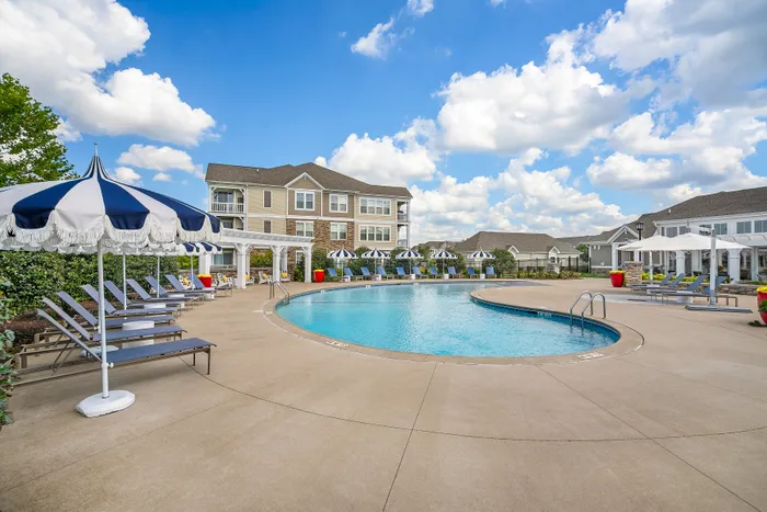 large pool with building and clouds