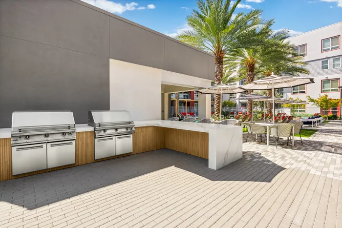 grilling station by outdoor seating area and pool