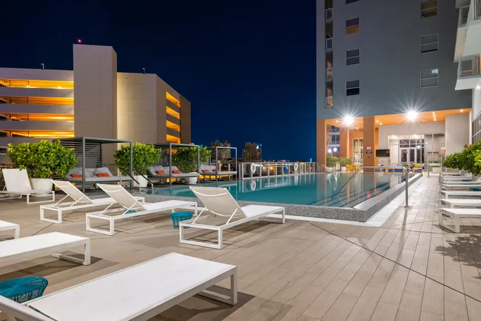 pool and lounge chairs at night Dadeland