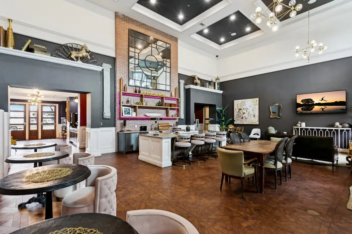 Luxurious and contemporary communal space with elegant seating, modern art, and chic lighting, perfect for entertaining and relaxation.