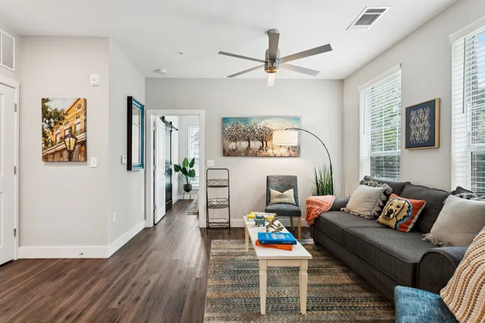Bright, modern living room with stylish decor, cozy seating, and abundant natural light.