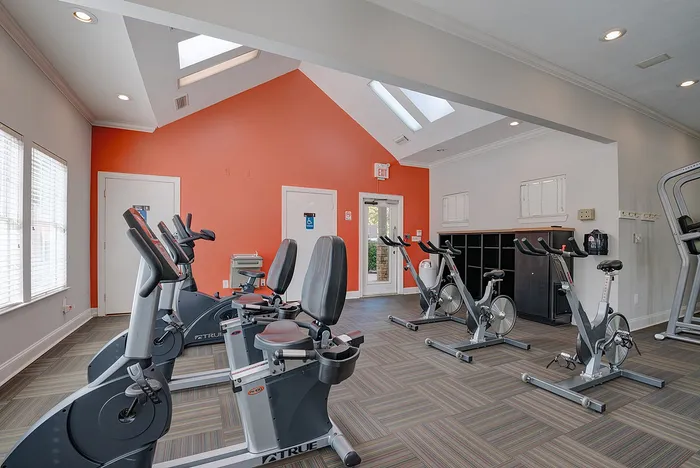 Bright and welcoming fitness center featuring modern exercise bikes and stylish skylights.