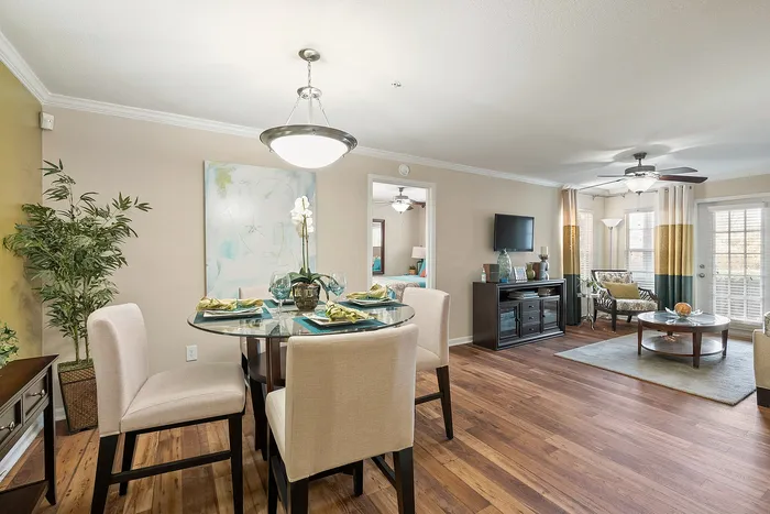 Elegant open-concept dining and living area with stylish decor, featuring a cozy, sunlit vibe, perfect for entertaining.