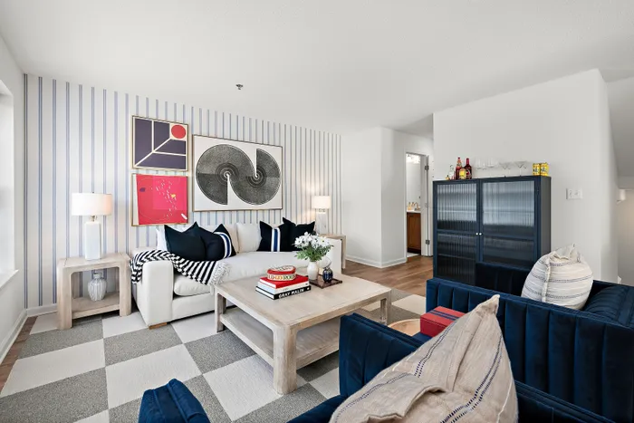 Chic living room with modern decor, featuring a comfy sofa, stylish art pieces, and a cozy ambiance perfect for relaxation.