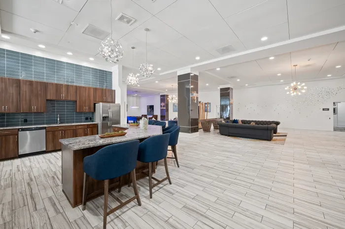 Luxurious open-concept living space with modern kitchen, elegant lighting, and sophisticated decor.