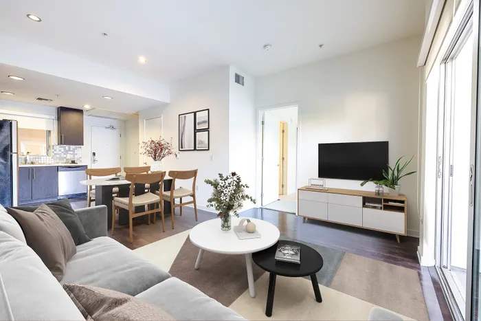 Elegant open-concept living space with a cozy seating area, stylish dining set, and modern kitchen, perfect for a contemporary lifestyle.