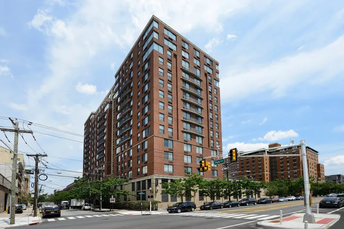Impressive urban apartment building with modern architecture and large windows, capturing vibrant city living atmosphere.