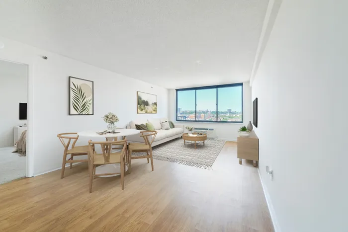 Bright and modern living space with natural light, elegant dining area, and expansive city views from large windows.