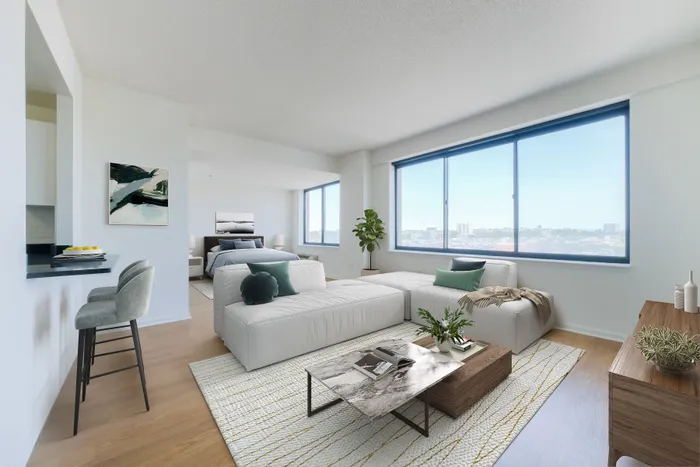 Bright and inviting open-concept living space with modern decor, large windows showcasing a stunning city view, and cozy seating arrangements.