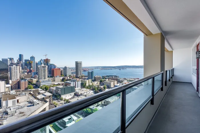 Spacious balcony with stunning city and waterfront views, perfect for relaxation and enjoying the skyline.