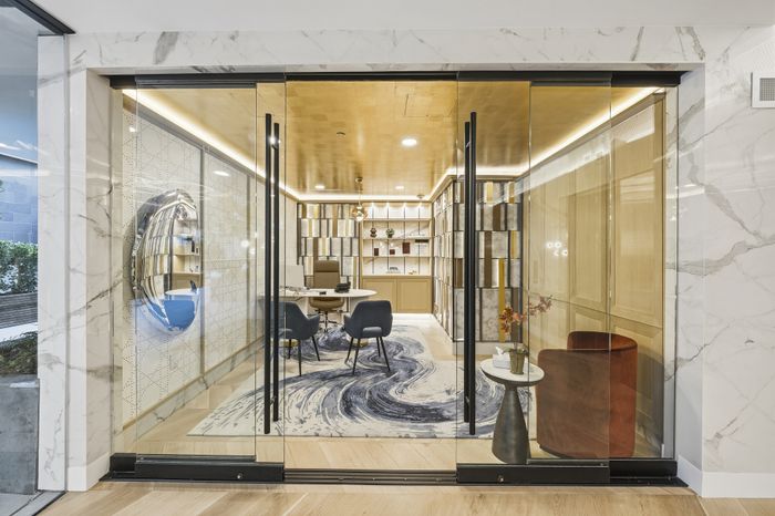 Elegant office space with large glass doors, modern furnishings, and stylish decor, ideal for a professional and inviting atmosphere.