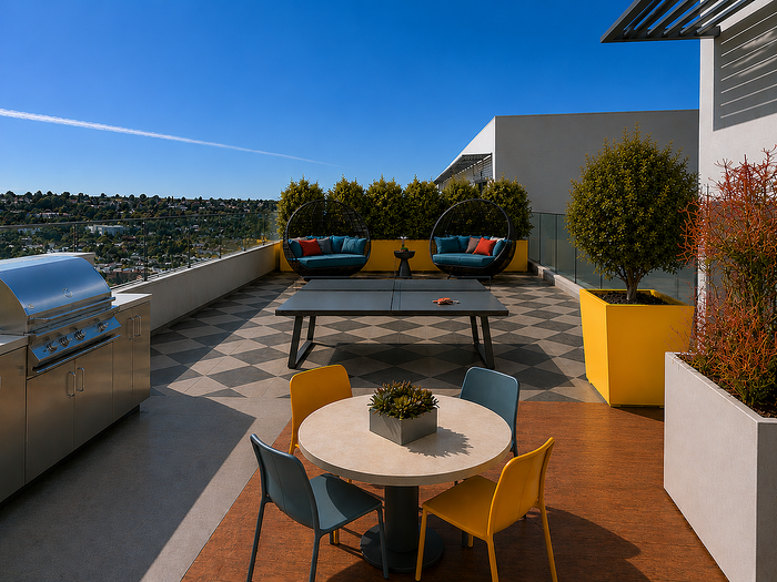 Luxurious rooftop terrace featuring modern seating areas, a sleek BBQ grill, and stunning city views amidst vibrant greenery.