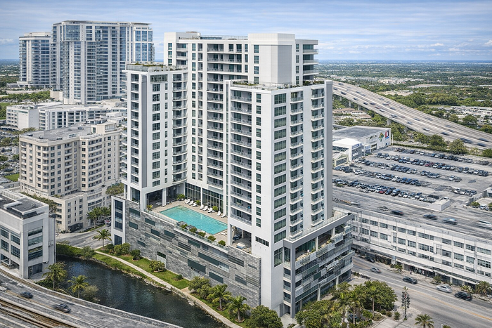 Stunning high-rise apartment building with a luxurious rooftop pool, surrounded by a vibrant urban landscape and lush greenery.