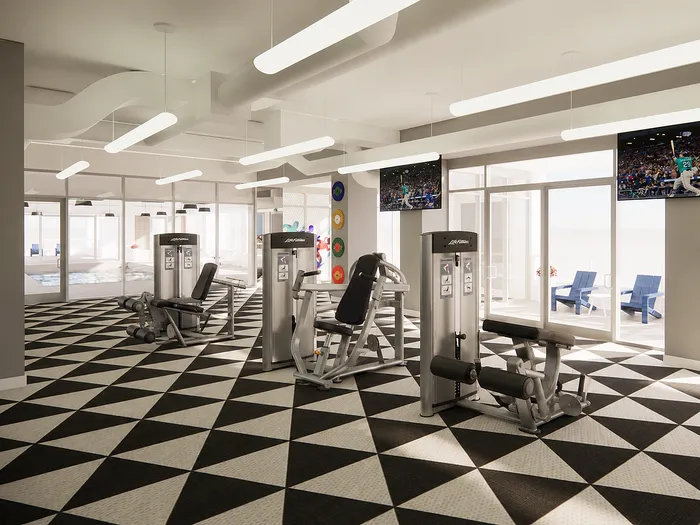 Modern gym with sleek exercise equipment, geometric patterned flooring, and bright lighting, offering a vibrant workout environment.