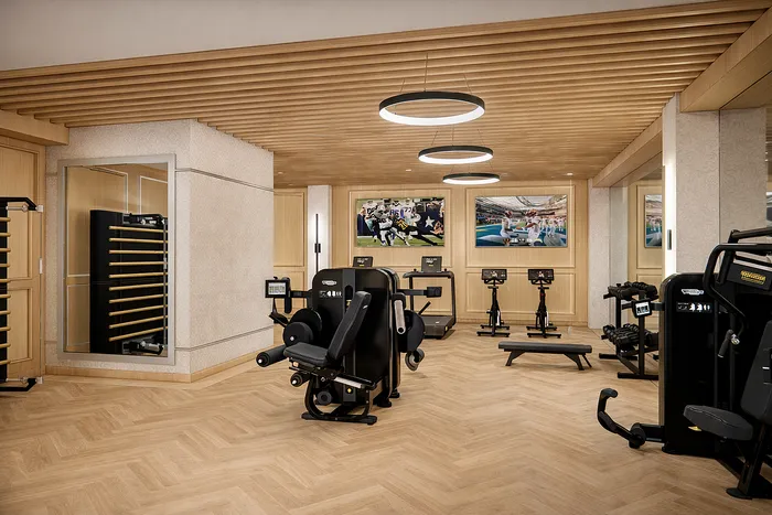 Luxurious gym space with modern fitness equipment, wooden accents, and stylish lighting for an upscale workout experience.