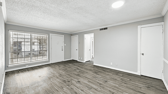 Bright, airy living room with large window, elegant hardwood floors, and modern neutral tones.