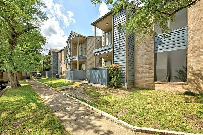 Charming apartment complex with modern architecture, featuring cozy balconies and lush greenery, perfect for comfortable living.