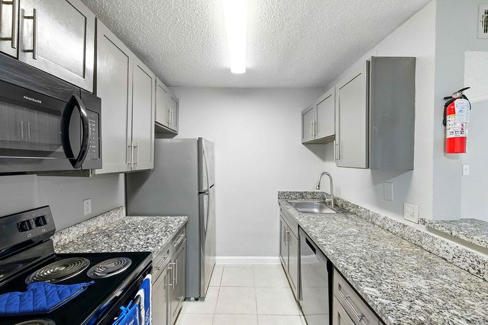 Modern kitchen with sleek granite countertops, stainless steel appliances, and ample cabinet space.