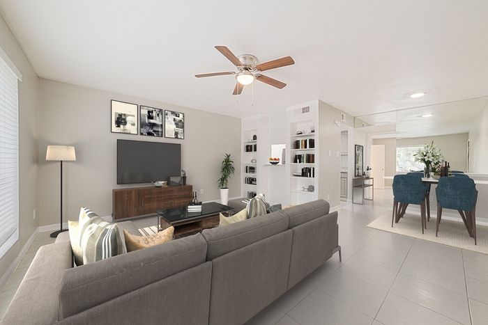 Inviting open-concept living room with modern decor, plush seating, and a sleek entertainment center, perfect for relaxation and entertaining.