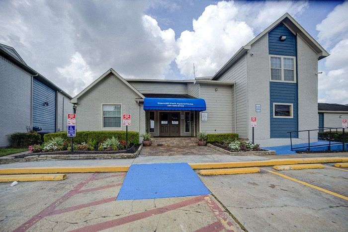 Inviting exterior of Stancilf Park Apartments with vibrant landscaping and a welcoming entryway.