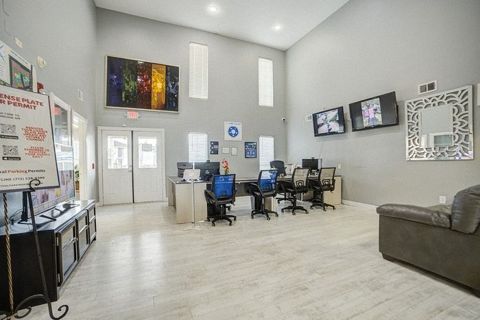 Bright and welcoming office space with modern decor, comfortable seating, and vibrant artwork, ideal for a productive environment.