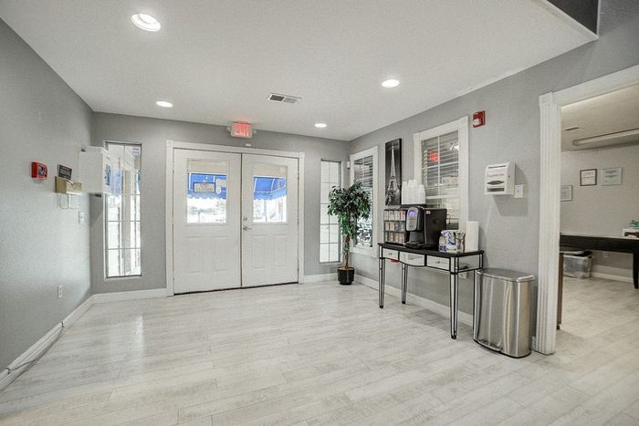 Bright and welcoming lobby with sleek flooring, modern coffee station, and elegant decor perfect for relaxing.
