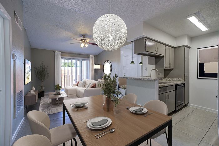 Inviting open-concept apartment with modern kitchen, cozy living room, and elegant dining area featuring stylish decor.
