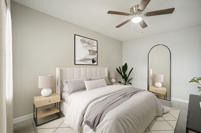 Modern bedroom with elegant decor, featuring a cozy bed, stylish nightstands, and a large mirror for a spacious feel.