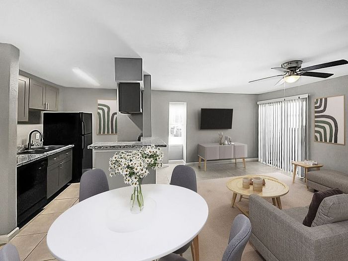 Contemporary open-plan living space featuring a stylish kitchen, cozy dining area with chic chairs, and elegantly decorated living room.
