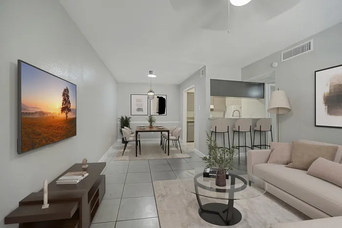 Modern open-plan apartment with stylish living room, elegant dining area, and sleek kitchen bar under soft lighting.