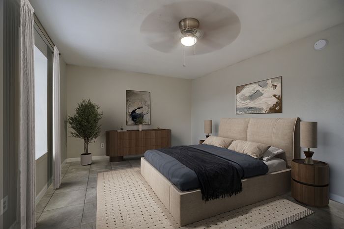 Elegant bedroom with contemporary design, featuring a cozy bed, modern artwork, and abundant natural light.