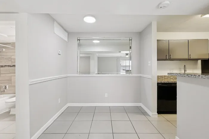 Chic apartment interior with sleek granite countertops, modern cabinetry, and a spacious open-plan layout.