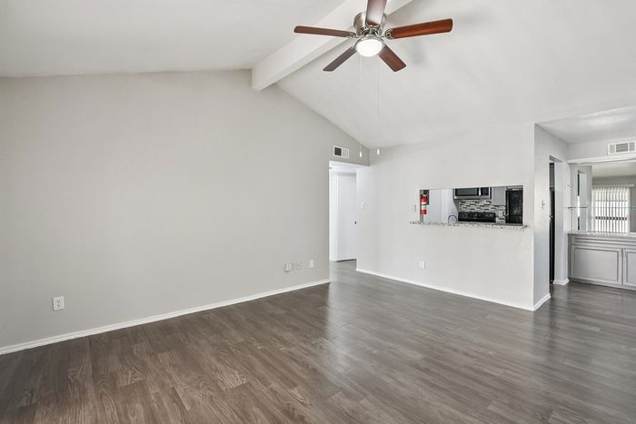 Bright and airy living space with modern ceiling fan and elegant wood flooring, perfect for stylish urban living.