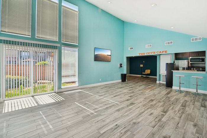 Bright and airy apartment with expansive windows, modern kitchen, and sleek flooring, offering a perfect blend of style and comfort.