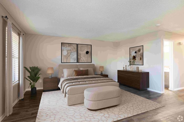 Elegant bedroom with modern decor, featuring a cozy bed, stylish artwork, and abundant natural light.