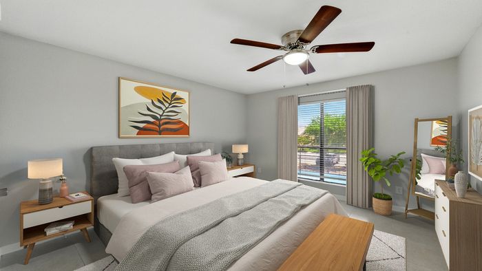 Inviting bedroom with modern decor, featuring a plush bed with soft pillows, bedside tables with stylish lamps, and a large window offering a sunny view. Accented by a leafy plant and elegant artwork.