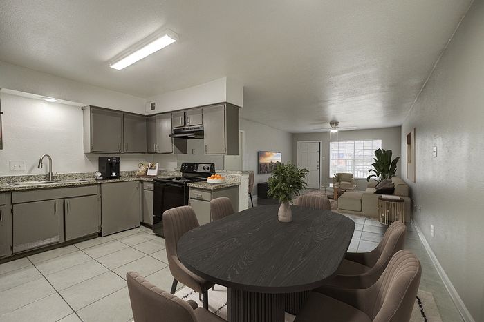 Modern open-concept kitchen and living area with sleek cabinetry, cozy seating, and ample natural light.