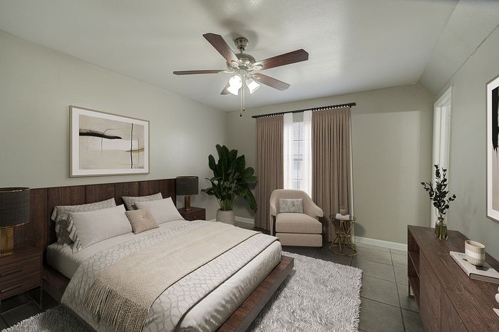 Elegant master bedroom with modern decor, featuring a comfortable bed, stylish armchair, and soft natural light filtering through draped windows.