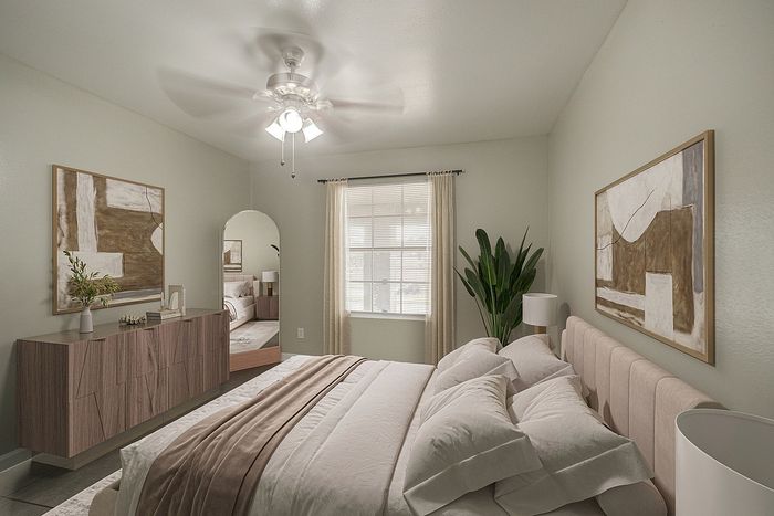 Elegant bedroom with plush bedding, sophisticated decor, and natural light enhancing the serene ambiance.