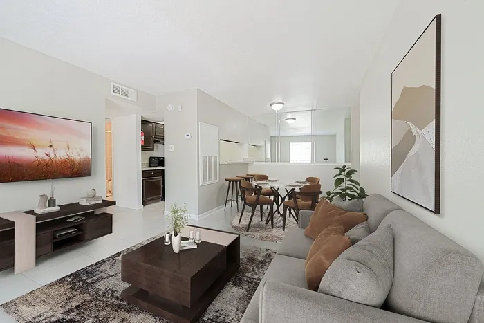 Inviting open-concept living space with modern decor, cozy seating area, and bright dining nook.