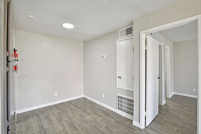 Bright and modern interior featuring sleek tile flooring and a neutral color palette, seamlessly connecting rooms for an open and inviting atmosphere.