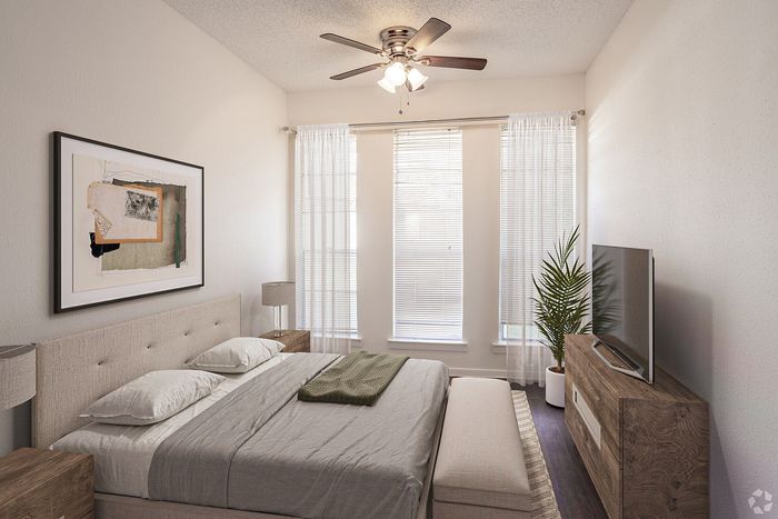 Bright and airy bedroom with elegant neutral tones, featuring a cozy bed, chic wooden furniture, and large windows with sheer curtains.