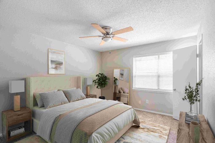 Bright and airy bedroom featuring a cozy bed with elegant bedding, modern nightstands, ceiling fan, and a large window illuminating the space.