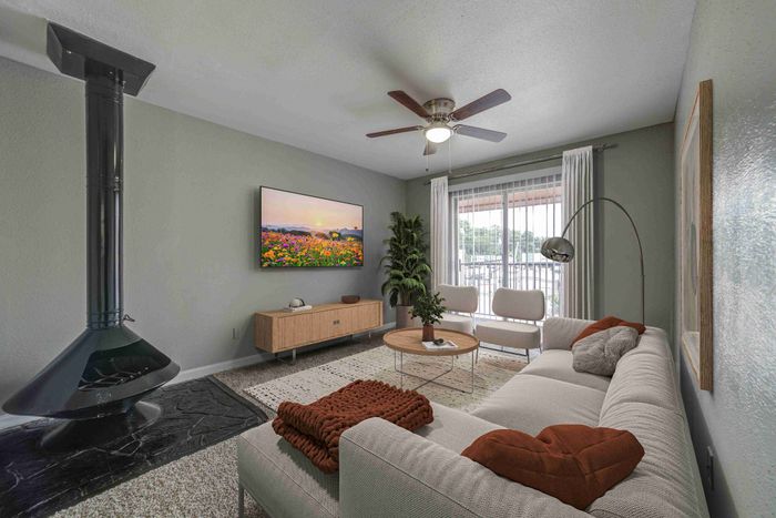 Inviting living room with cozy sectional, modern fireplace, large flat-screen TV, and elegant decor, perfect for relaxation.