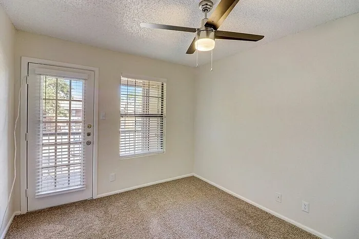 A1 bedroom with window and ceiling fan