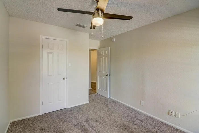 A1 bedroom with natural light and ceiling fan