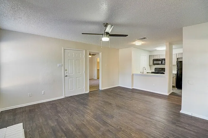 B1 living and dining area with ceiling fan