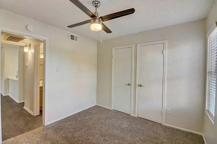 B1 guest bedroom with ceiling fan and window