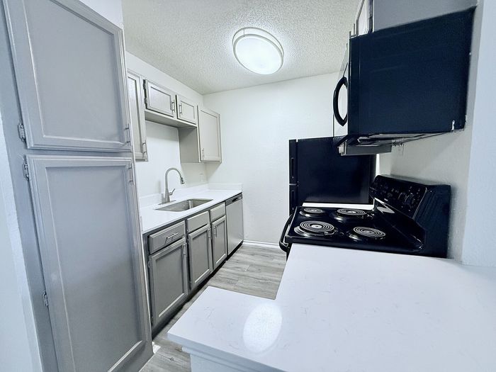 C1 apartment kitchen with cabinets and appliances