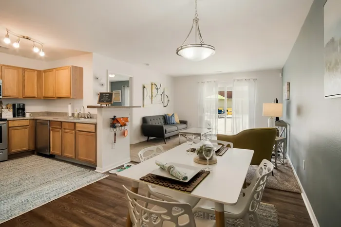 Kitchen with stainless steel appliances and island at Liv Wildwood apartments in Ludington, Michigan.